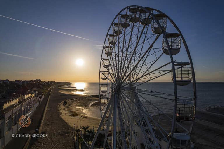 Filming Essex. Clacton on Sea Ferris wheel at sunrise, aerial shot, cinematic drone footage